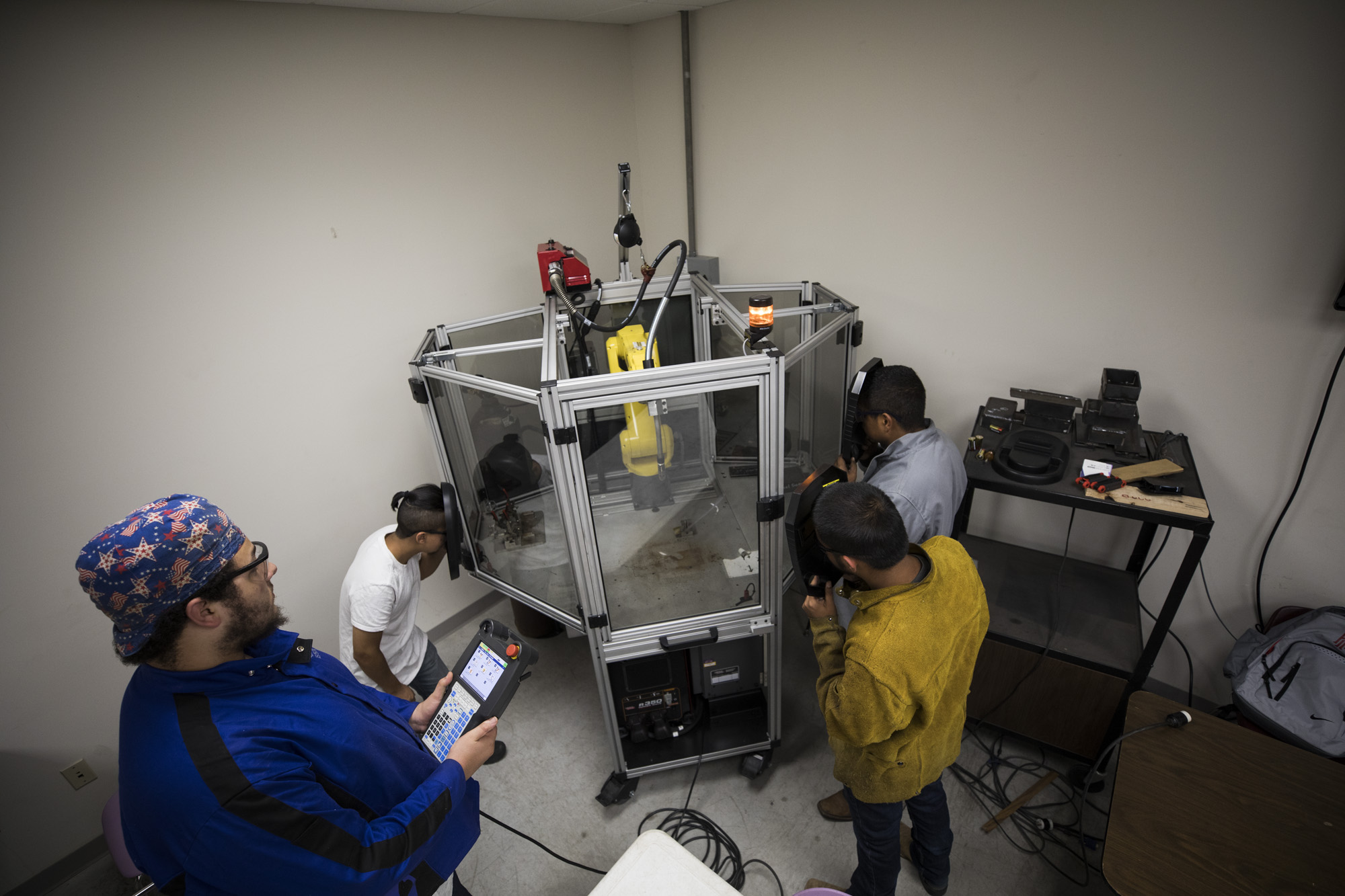 Students operating the robotic welder