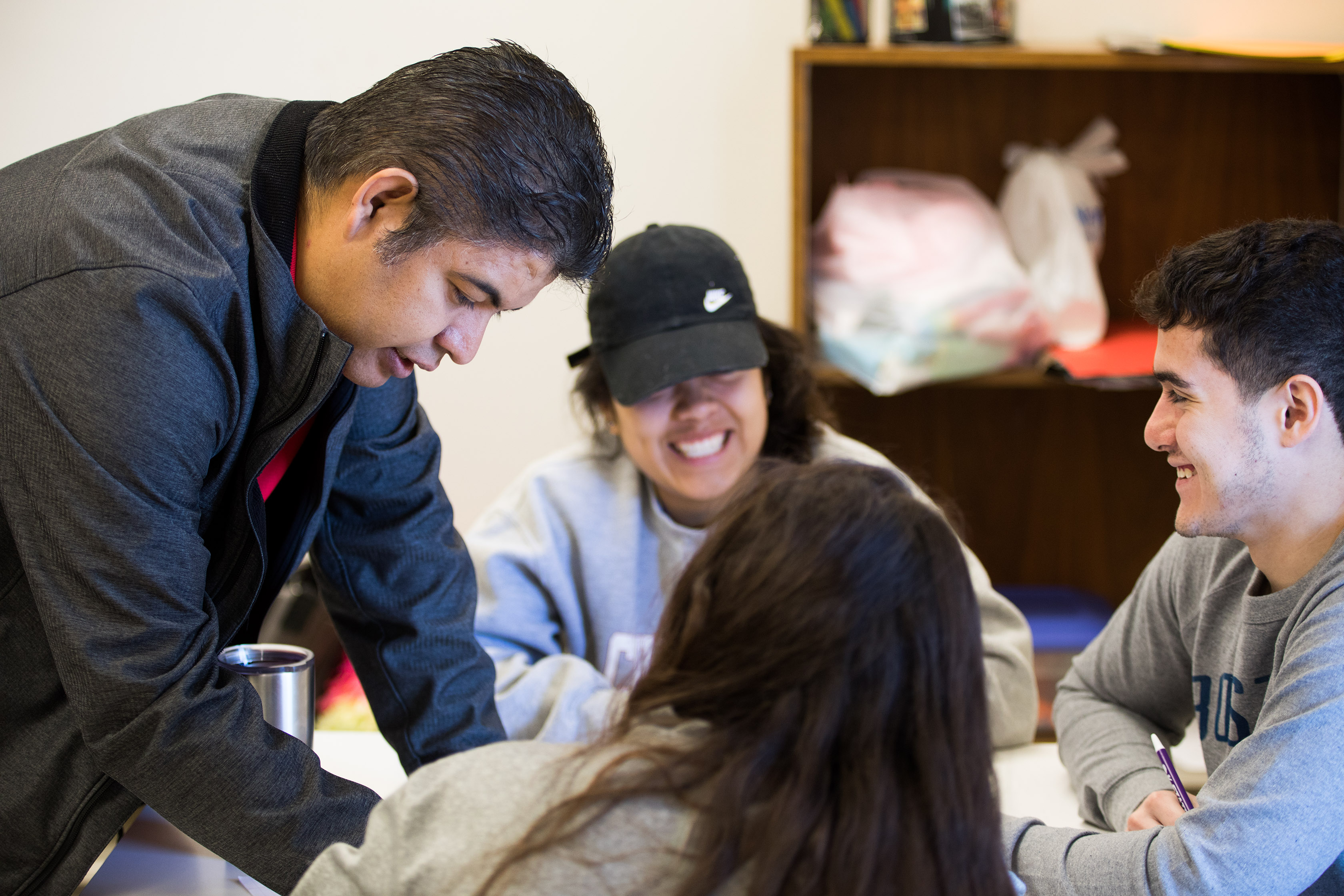 SARC Director Jorge Estrella works with students in the International Club