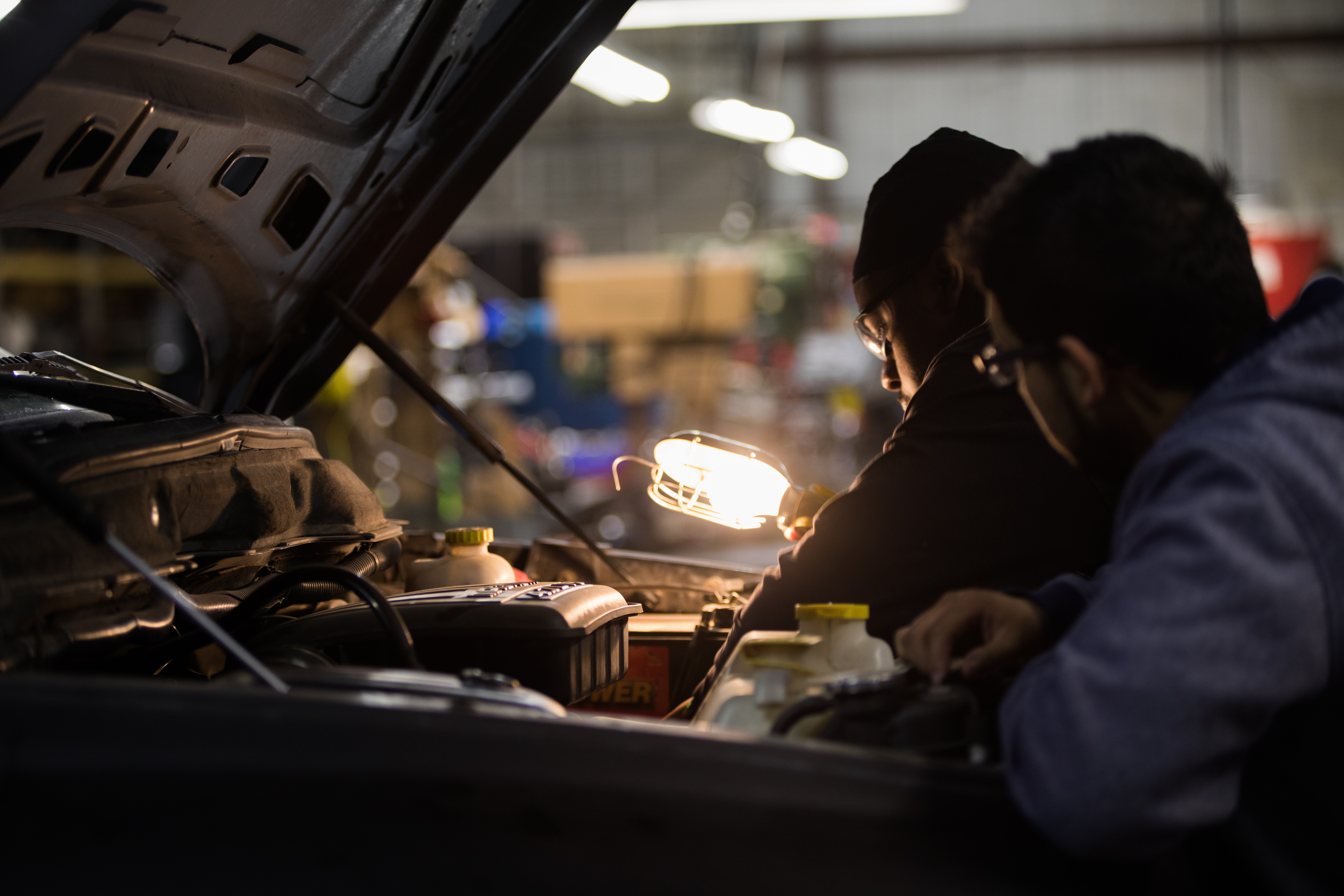 DC3 students working on an an engine in the Automobile Mechanics Technology program