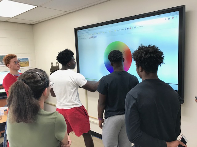 Students engage with new classroom technology, including the new smart boards