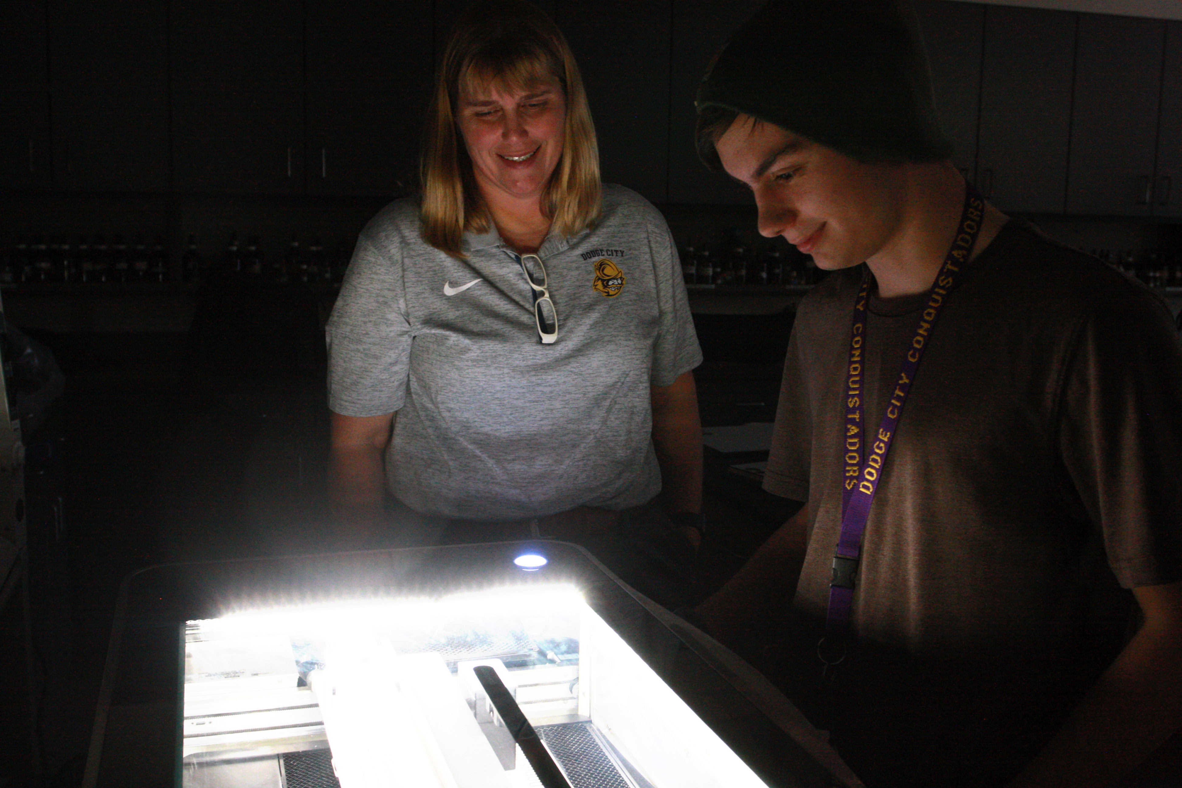 Professor Curtis and student Daniel Ulichnie watching the Glowforge at work