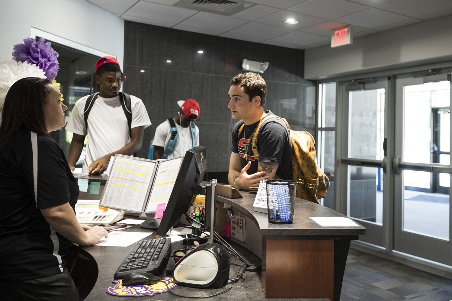 A student makes inquiries at the front desk of the DC3 student services department